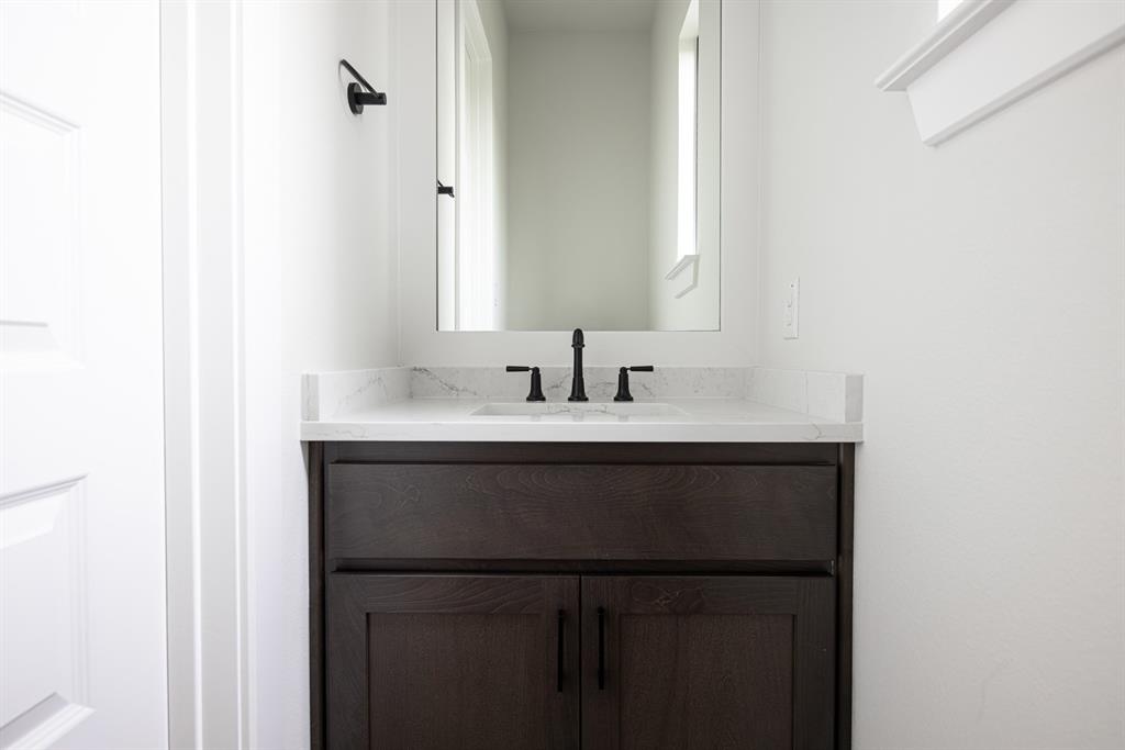 207 Links Court Heath, TX 75126 - Photo 33 of 39 a bathroom with a sink and a mirror