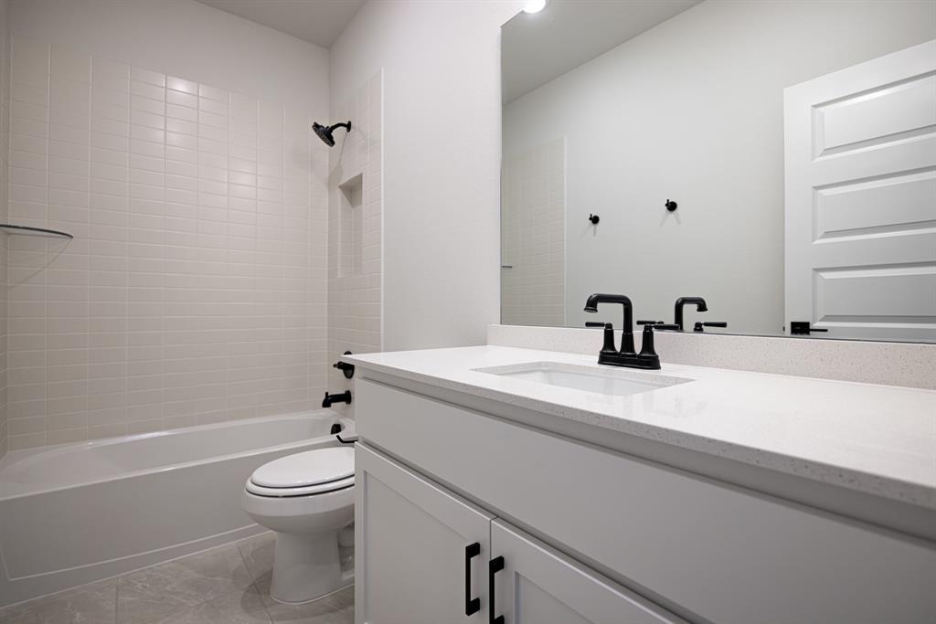 207 Links Court Heath, TX 75126 - Photo 35 of 39 a bathroom with a sink a toilet and shower