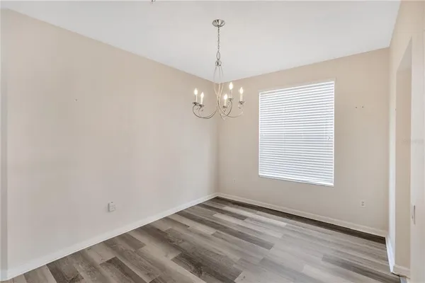 a view of an empty room with a chandelier