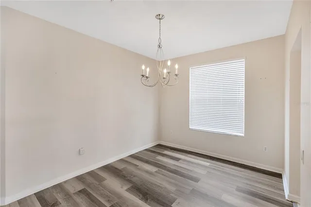 a view of an empty room with a chandelier