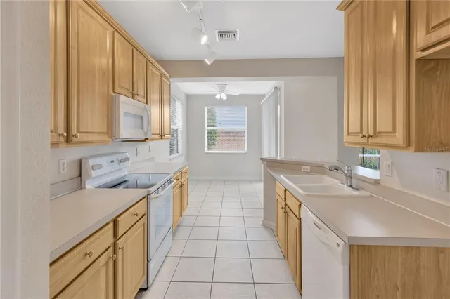a kitchen with stainless steel appliances granite countertop a sink and a white cabinets