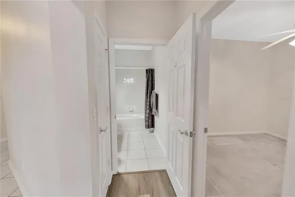 a bathroom with a tub sink and a mirror