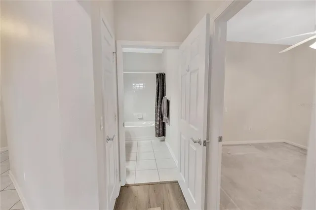 a bathroom with a tub sink and a mirror