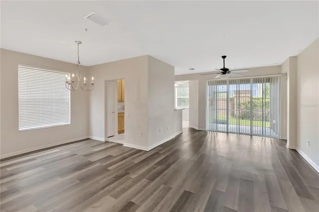 a view of wooden floor and window in a room