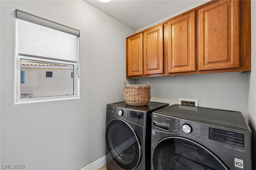 1176 Butternut Ranch Court Henderson, NV 89052 - Photo 22 of 60 Functional laundry space featuring modern appliances and convenient overhead cabinetry.