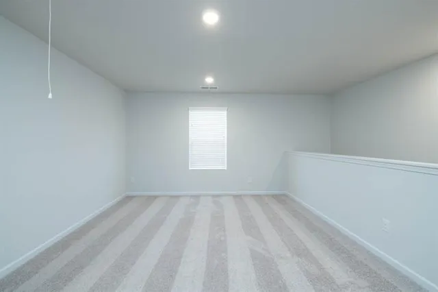 a view of room with window and pillar in it