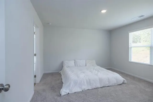 a bedroom with a bed and a window