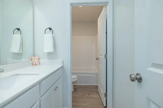 a bathroom with a sink and mirror with shower