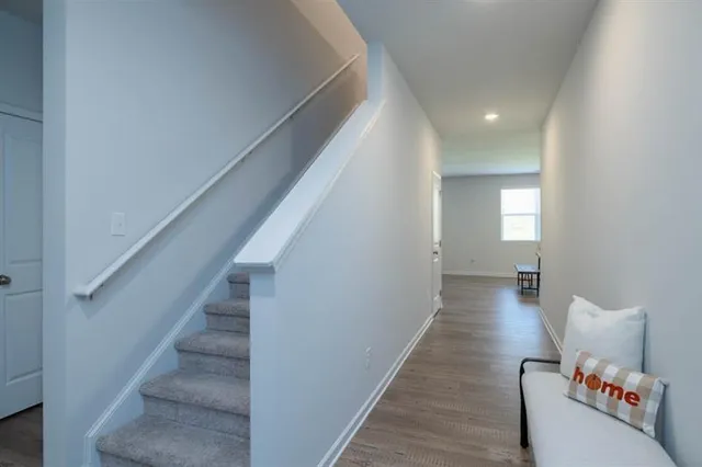 a hallway with wooden floor and entryway