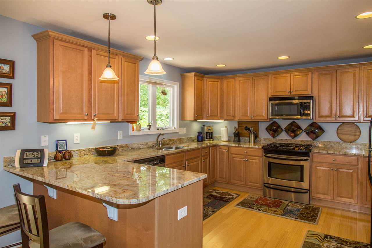 50 Oak Grove Road Palmyra, VA 22963 - Photo 3 of 50 a kitchen with a sink a stove a microwave cabinets and a window