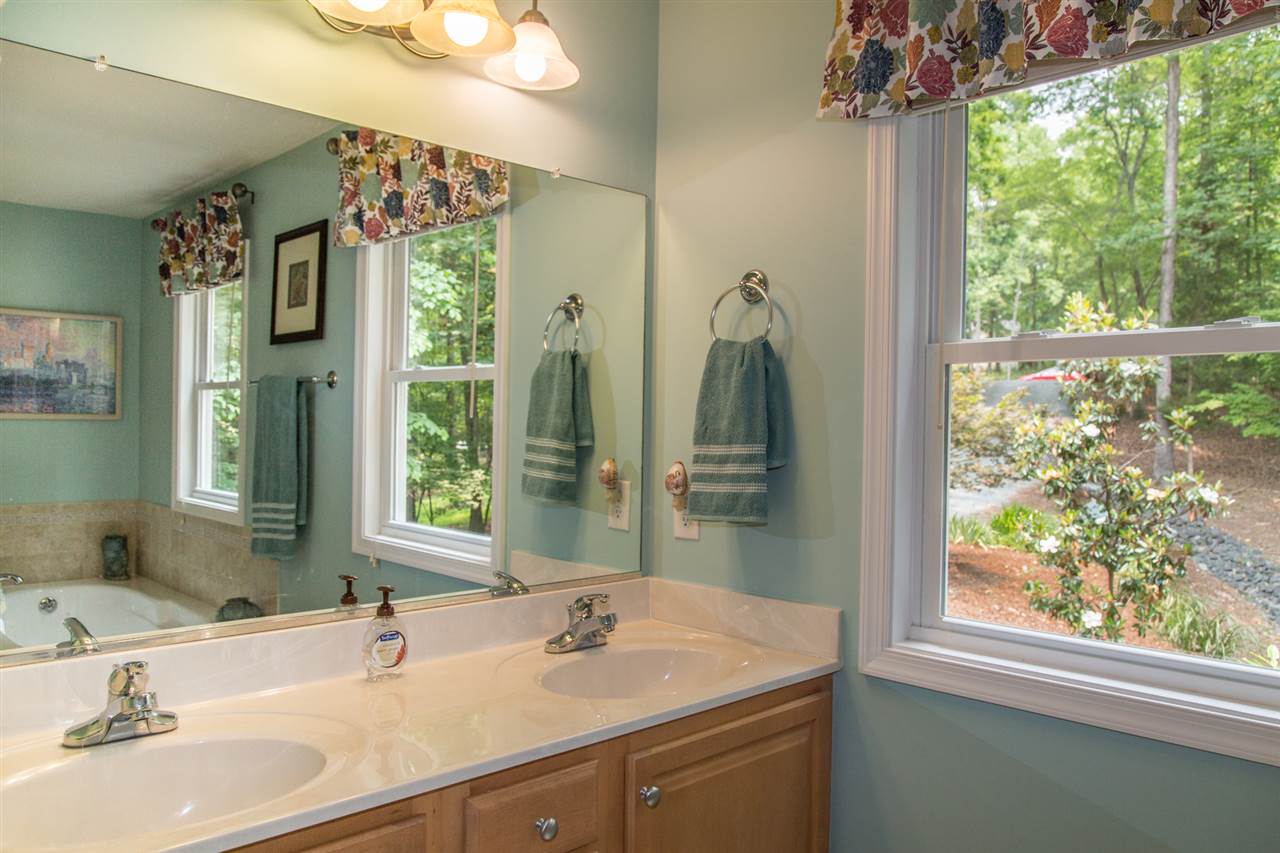50 Oak Grove Road Palmyra, VA 22963 - Photo 36 of 50 a bathroom with a double vanity sink and a mirror