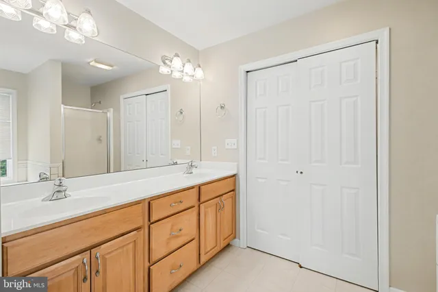a bathroom with a double vanity sink and a mirror