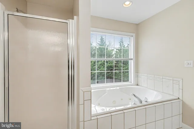 a bath tub sitting next to a window