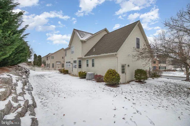 a view of a house with a snow in the yard