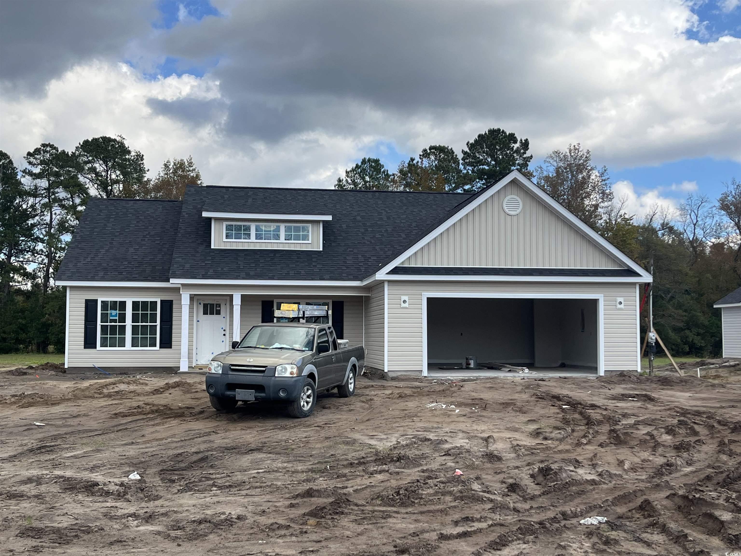 View of front of home with a shingled roof, a garage, and a porch
