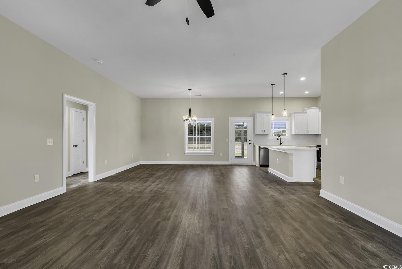 3255 Red Bluff Road Loris, SC 29569 - Photo 12 of 38 Unfurnished living room with dark wood-style floors, a chandelier, recessed lighting, and ceiling fan