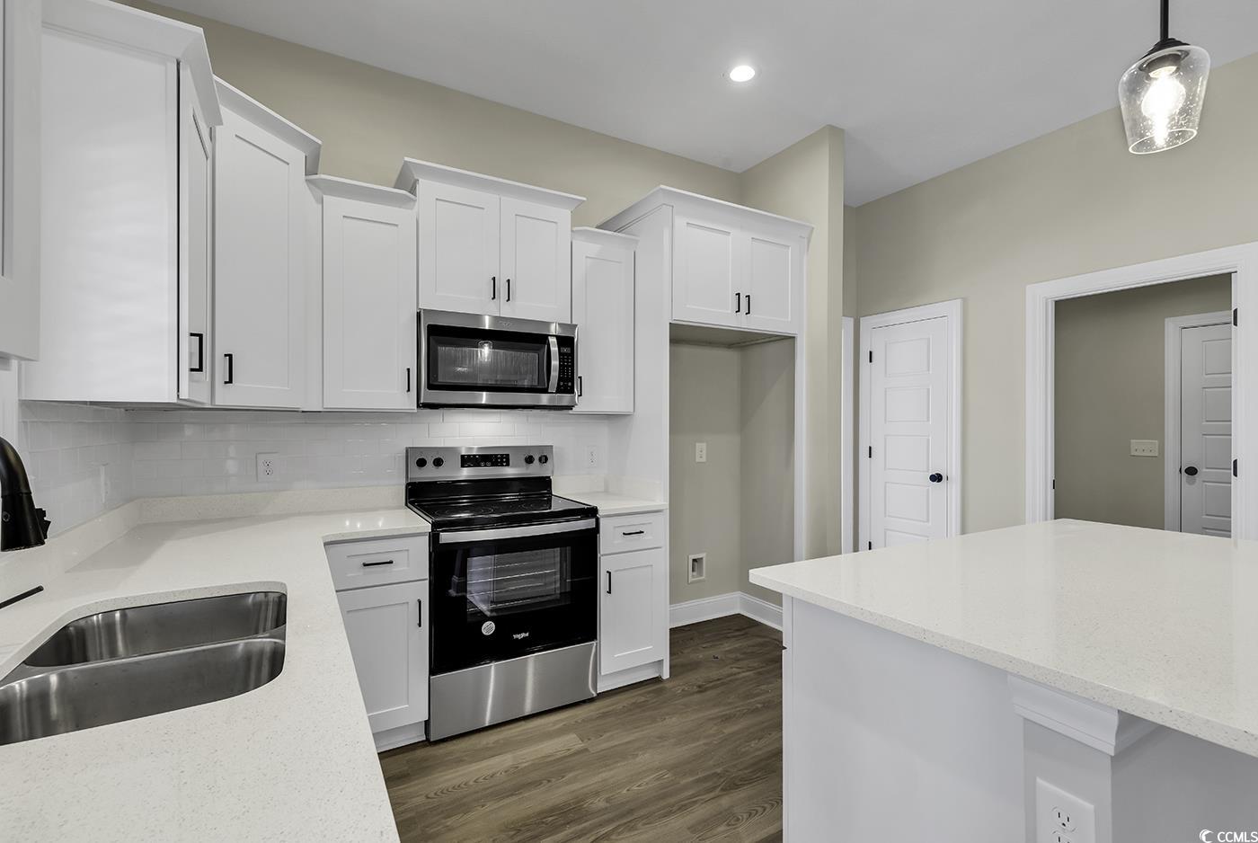 3255 Red Bluff Road Loris, SC 29569 - Photo 18 of 38 Kitchen featuring stainless steel appliances, white cabinetry, light stone countertops, tasteful backsplash, and recessed lighting