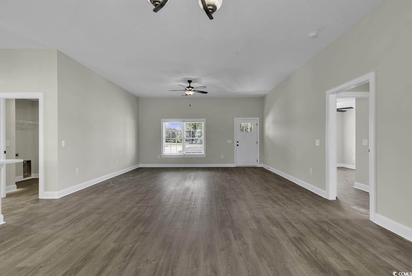 3255 Red Bluff Road Loris, SC 29569 - Photo 23 of 38 Unfurnished living room featuring dark wood finished floors and ceiling fan