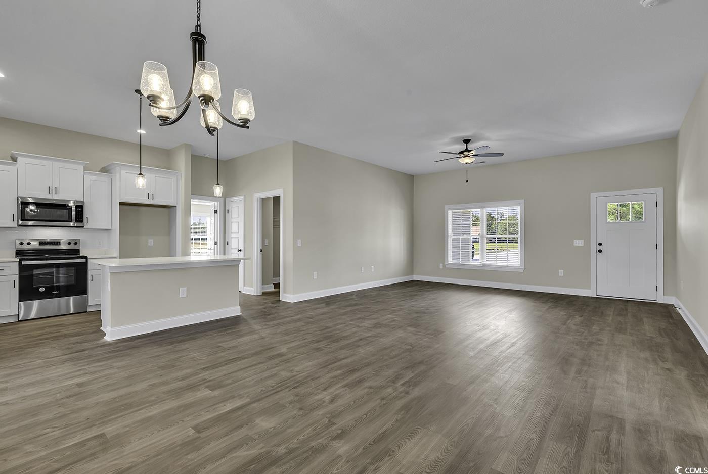 3255 Red Bluff Road Loris, SC 29569 - Photo 24 of 38 Unfurnished living room featuring a chandelier, dark wood-type flooring, and ceiling fan
