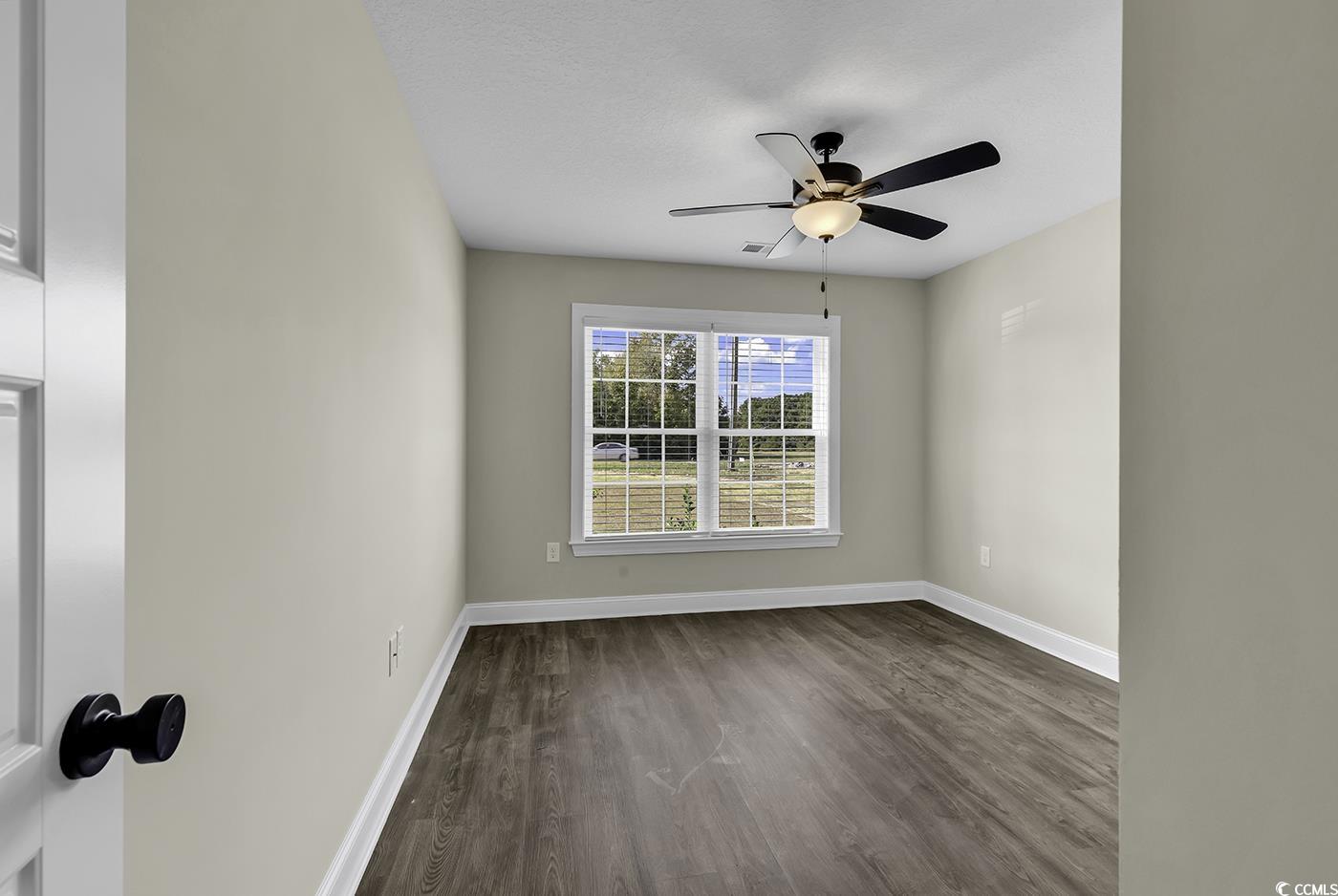 3255 Red Bluff Road Loris, SC 29569 - Photo 25 of 38 Unfurnished room featuring dark wood-type flooring and ceiling fan