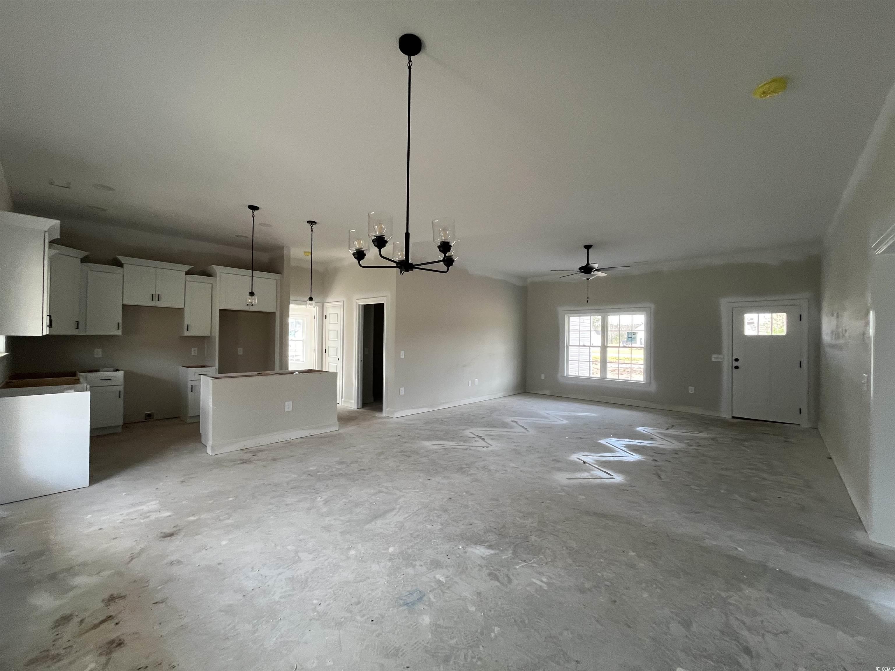 3255 Red Bluff Road Loris, SC 29569 - Photo 3 of 38 Unfurnished living room featuring ceiling fan and a chandelier