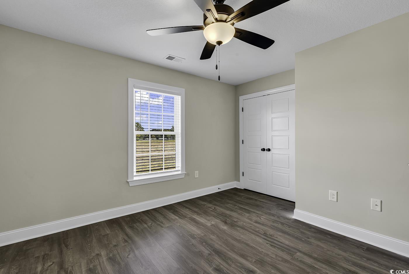 3255 Red Bluff Road Loris, SC 29569 - Photo 31 of 38 Unfurnished bedroom with dark wood-style floors, a closet, and a ceiling fan