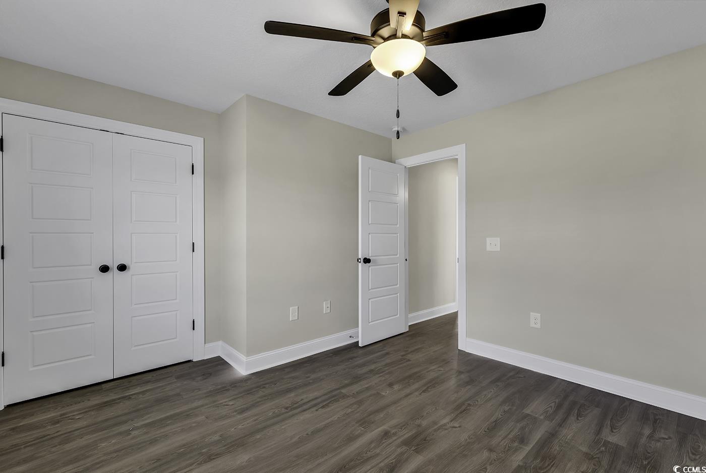 3255 Red Bluff Road Loris, SC 29569 - Photo 32 of 38 Unfurnished bedroom featuring dark wood-type flooring, a closet, and a ceiling fan