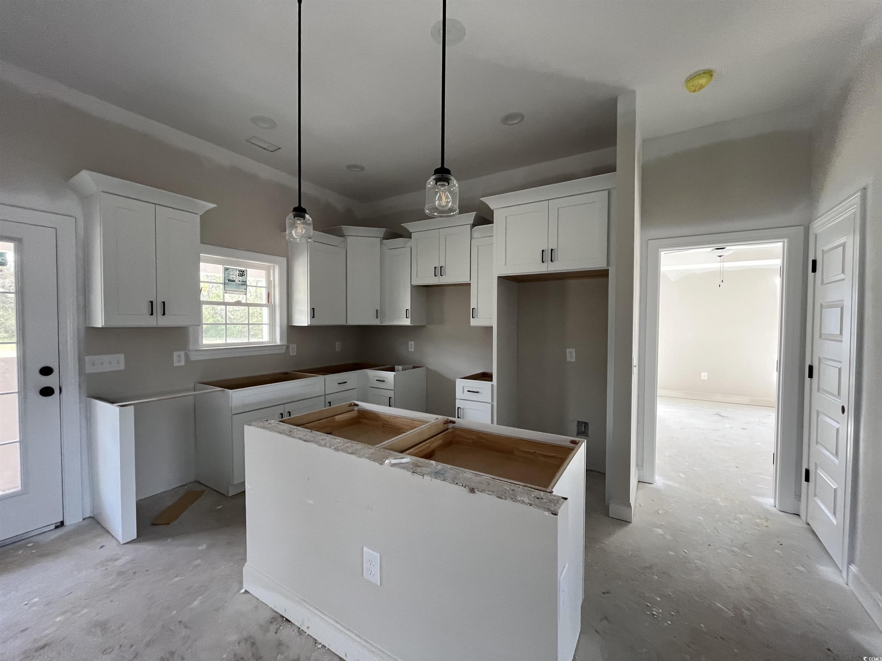 3255 Red Bluff Road Loris, SC 29569 - Photo 4 of 38 Kitchen featuring a kitchen island, decorative light fixtures, and white cabinetry