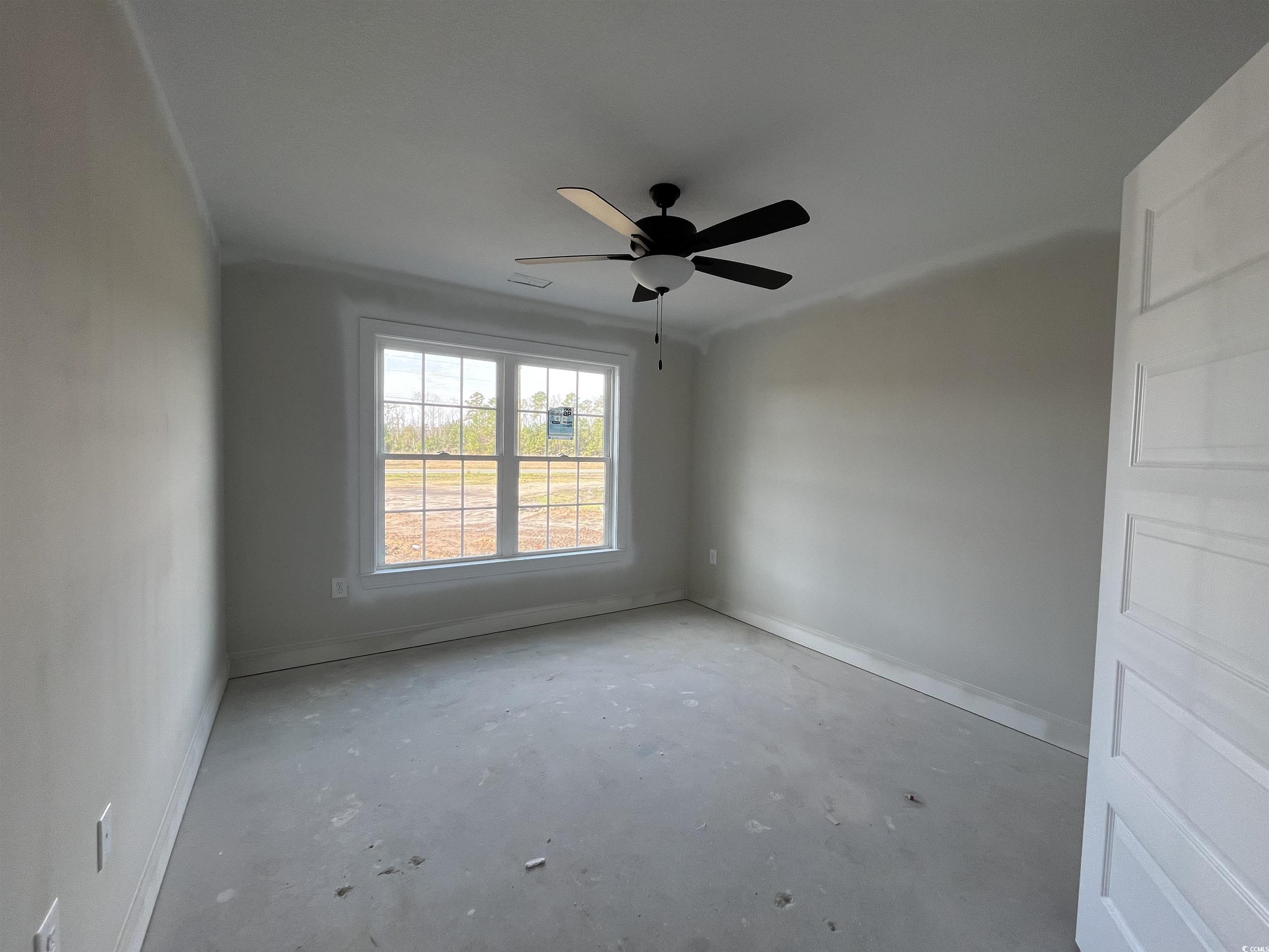 3255 Red Bluff Road Loris, SC 29569 - Photo 7 of 38 Unfurnished room featuring unfinished concrete floors and a ceiling fan
