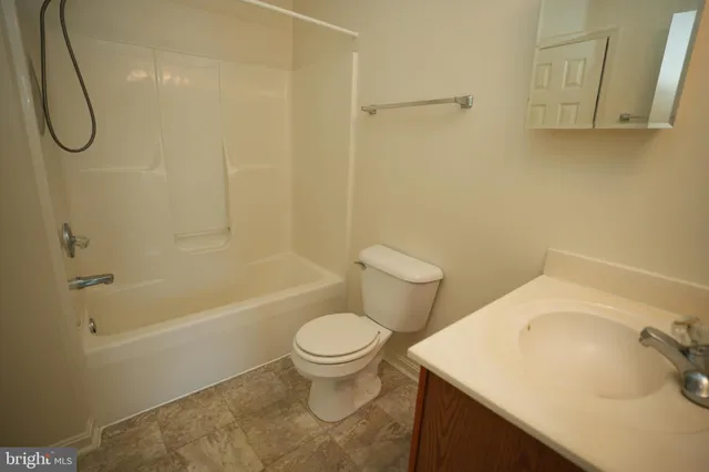 a bathroom with a sink a toilet and a shower