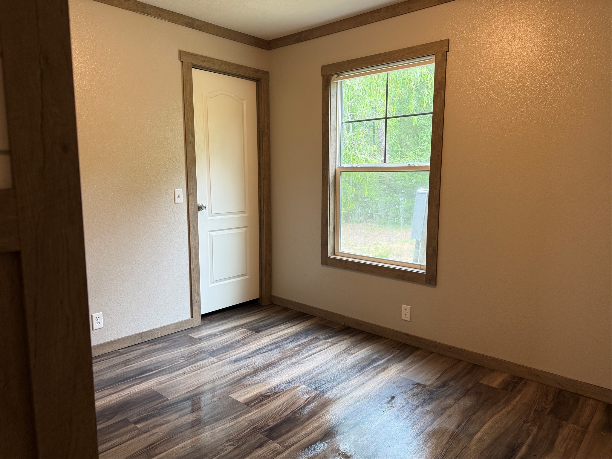 105 Saddle Surrey Road Coldspring, TX 77331 - Photo 43 of 48 a view of an empty room with wooden floor and a window