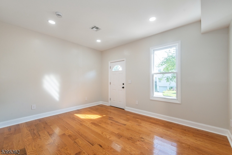 26 Washington Street, Unit 1 Montclair, NJ 07042 - Photo 15 of 34 an empty room with wooden floor and windows