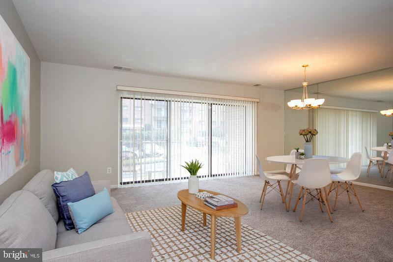 7202 Rockland Hills Drive, Unit 110 Baltimore, MD 21209 - Photo 1 of 13 a living room with furniture and a window