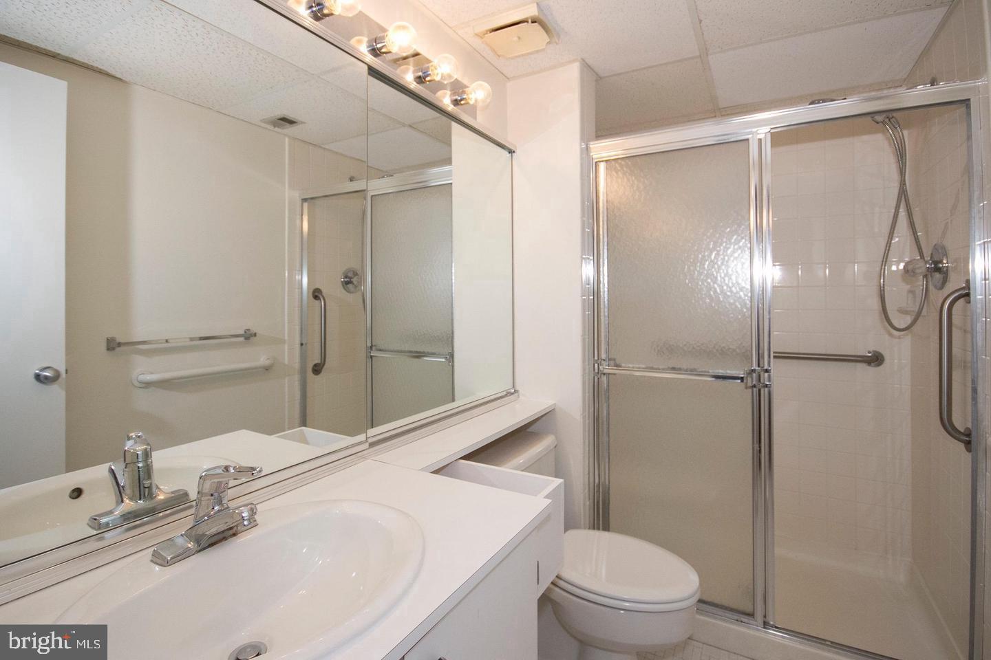 7202 Rockland Hills Drive, Unit 110 Baltimore, MD 21209 - Photo 11 of 13 a bathroom with a sink toilet and shower