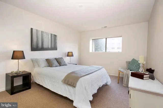 a bedroom with a bed and a window