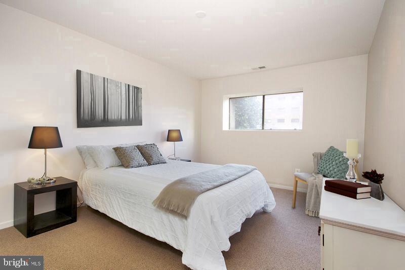 7202 Rockland Hills Drive, Unit 110 Baltimore, MD 21209 - Photo 8 of 13 a bedroom with a bed and a window
