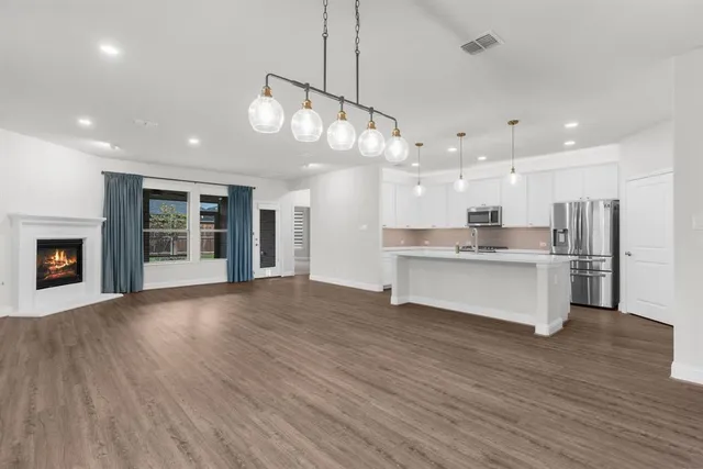 an aerial view of a swimming pool with outdoor seating