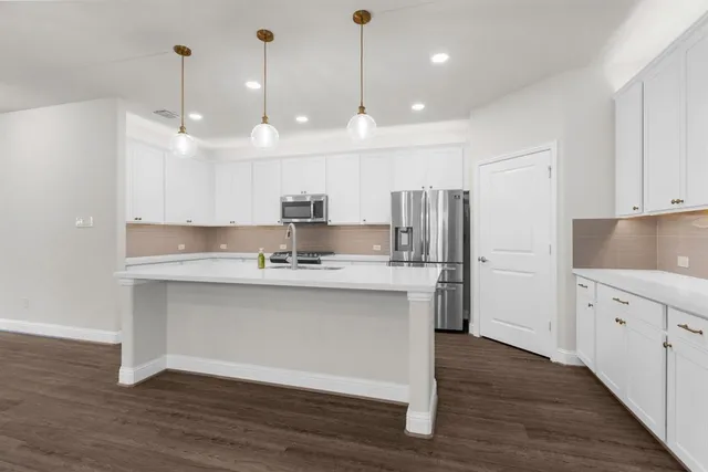 a view of kitchen with cabinets and wooden floor