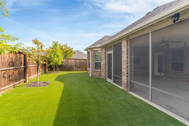 a view of backyard with a garden and entertaining space