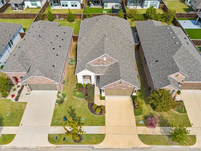a view of a backyard with wooden fence