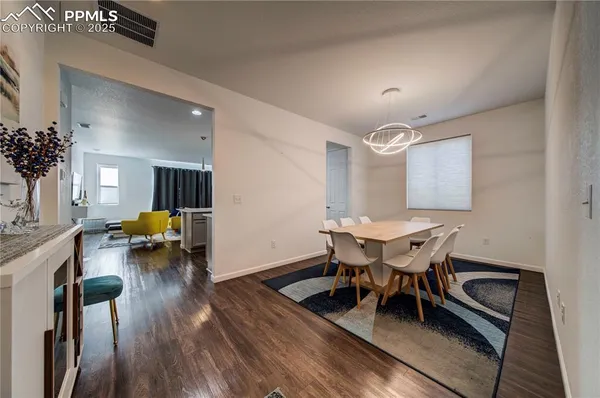 a view of a dining room with furniture and wooden floor