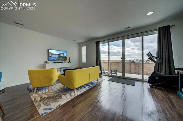 a living room with a couch and a floor to ceiling window