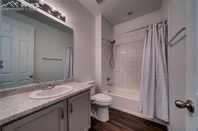 a bathroom with a granite countertop sink toilet a shower and a mirror