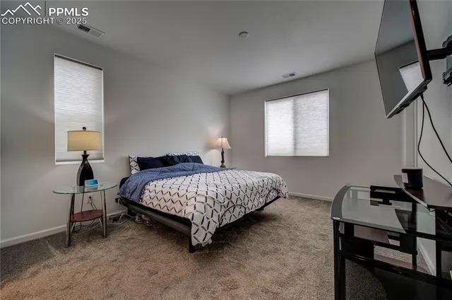 a bedroom with a bed a desk and chair