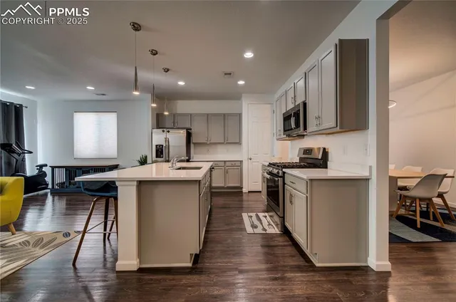 a kitchen with a sink appliances and cabinets