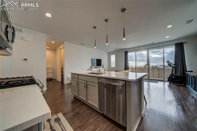 a kitchen with stainless steel appliances granite countertop a stove and a sink