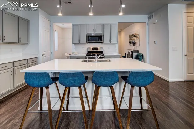 a kitchen with a dining table and chairs
