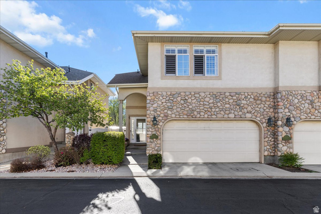 7824 South Sequoia Tree Lane Sandy, UT 84094 - Photo 2 of 43 View of front facade featuring stone siding, stucco siding, an attached garage, and driveway