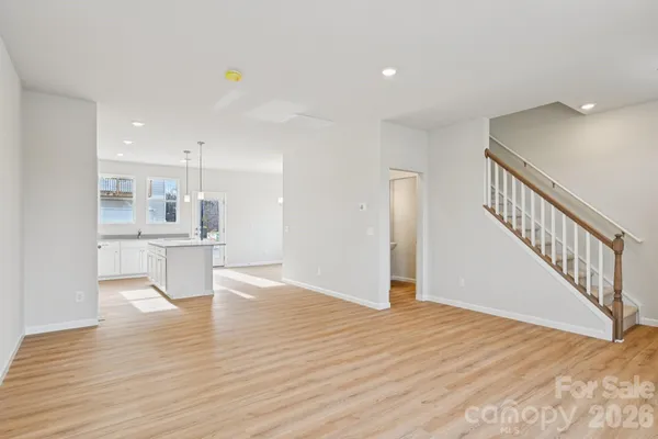 a view of a kitchen with furniture and wooden floor