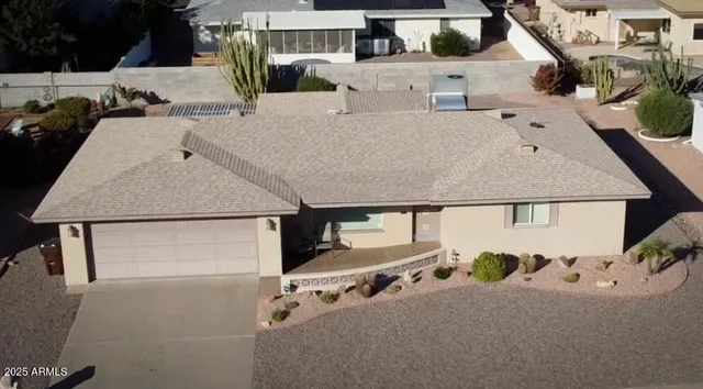 a kitchen with stainless steel appliances granite countertop a refrigerator a stove and a sink with wooden cabinets